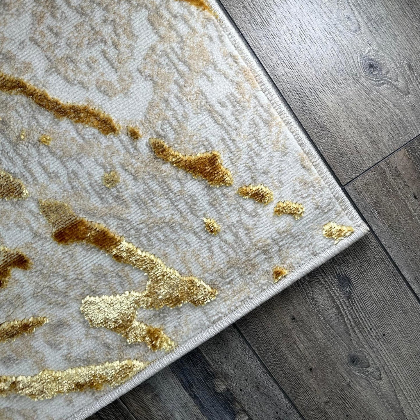 penina luxury area rug in beige and gray with gold circles abstract design