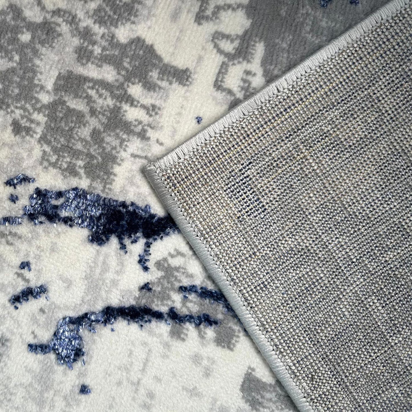 penina luxury area rug in gray with navy blue circles abstract design