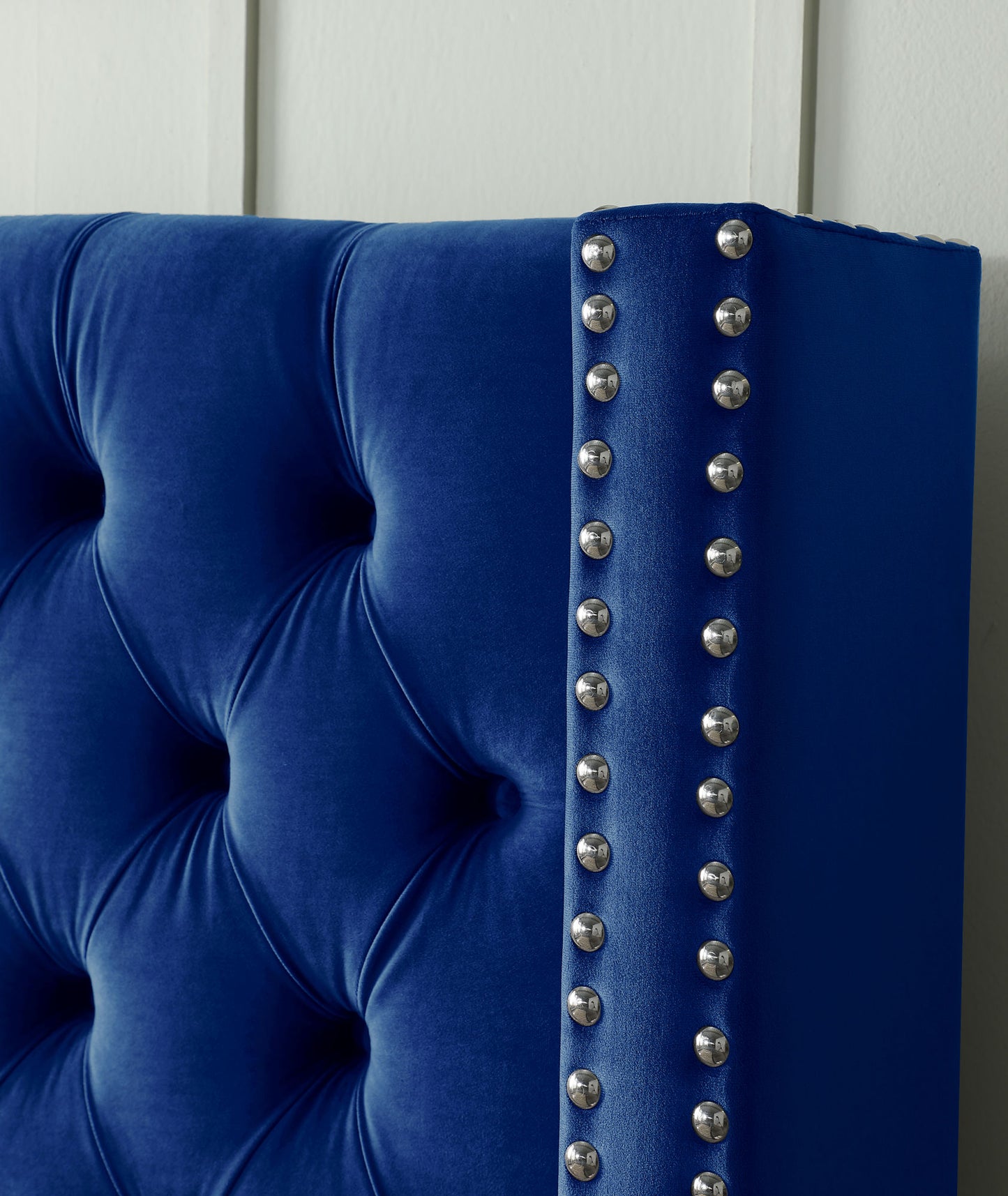 velvet upholstered bed with deep button tufting, blue